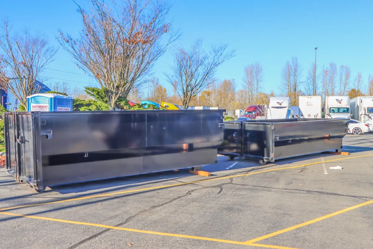 Professional dumpster rental service with roll-off container on residential driveway in San Diego